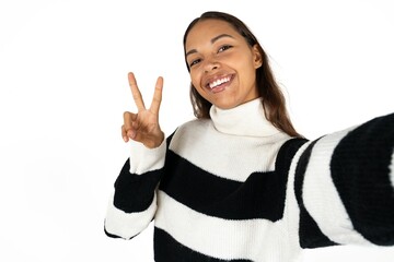 Positive Young woman take selfie make v-sign