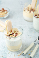 Milk mousse dessert with nuts in glasses