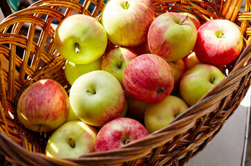 Wooden basket full of fresh apples. Overhead view of fresh organic apples harvesting concept