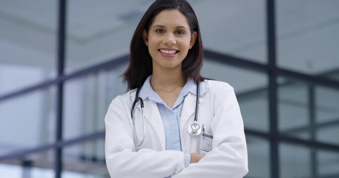 Smile, face and woman doctor with arms crossed in hospital for help, service or advice. Healthcare, pride and portrait of happy female nurse intern at clinic for consulting, treatment or checkup