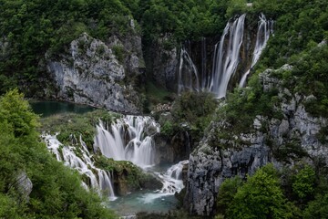 Tranquil scene of the Plitvice Lakes in Croatia with waterfalls surrounded by lush green foliage