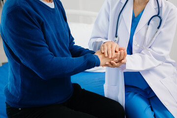 The doctor holds the patient’s. hand Healthcare and medical concept. In hospital.