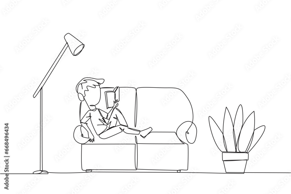 Poster continuous one line drawing boy sitting stretched out on the sofa reading a book. really like the co