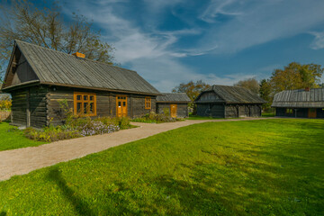Three wooden country cottages in the town of Niepolomice, Poland.