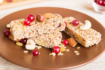 Various granola bars on table background. Cereal granola bars. Superfood breakfast bars with oats, nuts and berries, close up. Superfood concept