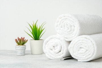 Obraz na płótnie Canvas Stacked clean fluffy towels in a bathroom