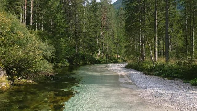Aerial drone fly above The Krumme Steyr river near the village Hinterstoder and famous lake Schiederweiher. Pure fresh water near Austrian Alps and mountains peaks. Soft colors, peace in nature.