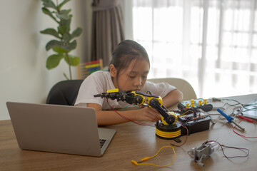 Young girl working on a robot design