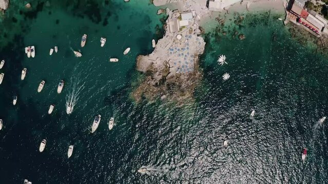 Overhead aerial view of Spiaggia di Marina Piccola in Italy's warm coastal waters.