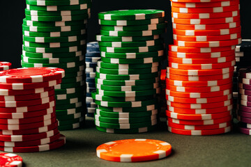 Lots of poker chips on green background
