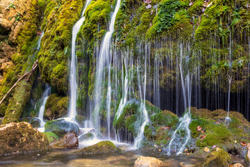 Natural river waterfall. Freshwater rapids, waterfalls, the river flows. Wild mountain river flowing through rock rapids.