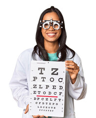 Young Filipina ophthalmologist holding optometry test chart - obrazy, fototapety, plakaty