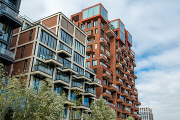 Modern housing building with balconies and brick facade