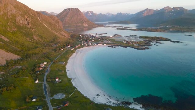 Aerial view of Ramberg beach bay with mountains landscape in the background. Flakstadoya Island, Lofoten Archipelago, Norway.