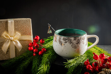 mug with hot chocolate on the black background with christmas decorations