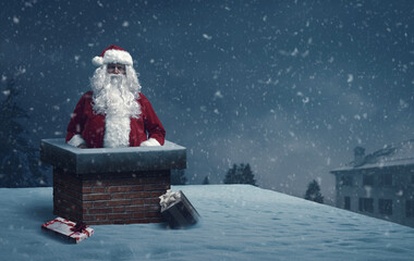 Funny Santa Claus stuck in a chimney