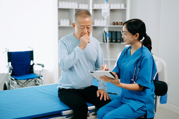  Friendly Female Head Nurse Making Rounds does Checkup on Patient Resting in Bed. She Checks tablet while Man Fully Recovering after Successful Surgery in hospital.