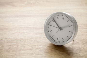 Silver alarm clock on wood table background