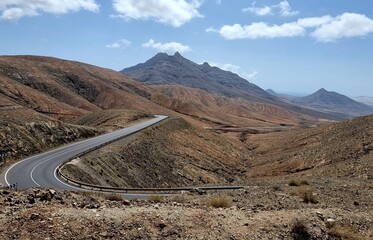 Asphalt winding road in the rugged desert mountains on the Spanish island of Fuerteventura