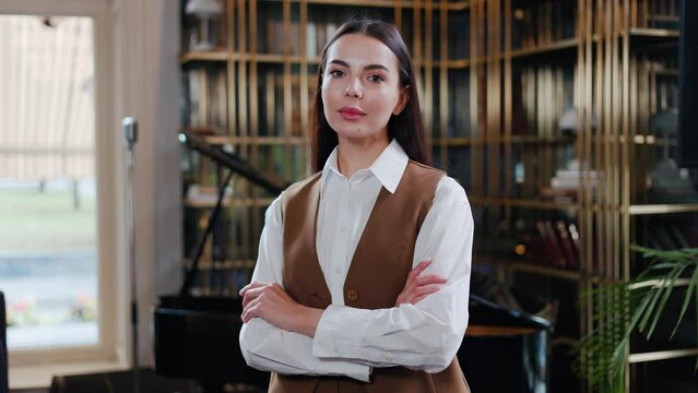 Confident chic strong businesswoman entrepreneur female leader caucasian woman girl cafe worker business owner looking at camera crossing hands confidence feminism in restaurant office. Face portrait.