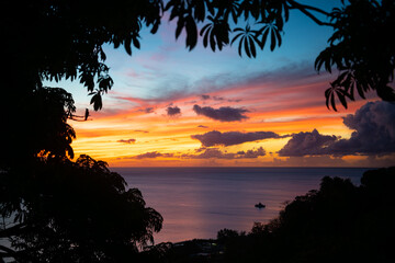 Colorful sunset with orange to blue sky and blue clouds above the Caribbean Sea in Saint Pierre on Martinique tropical island. French overseas department is a popular tourist and cruise destination.