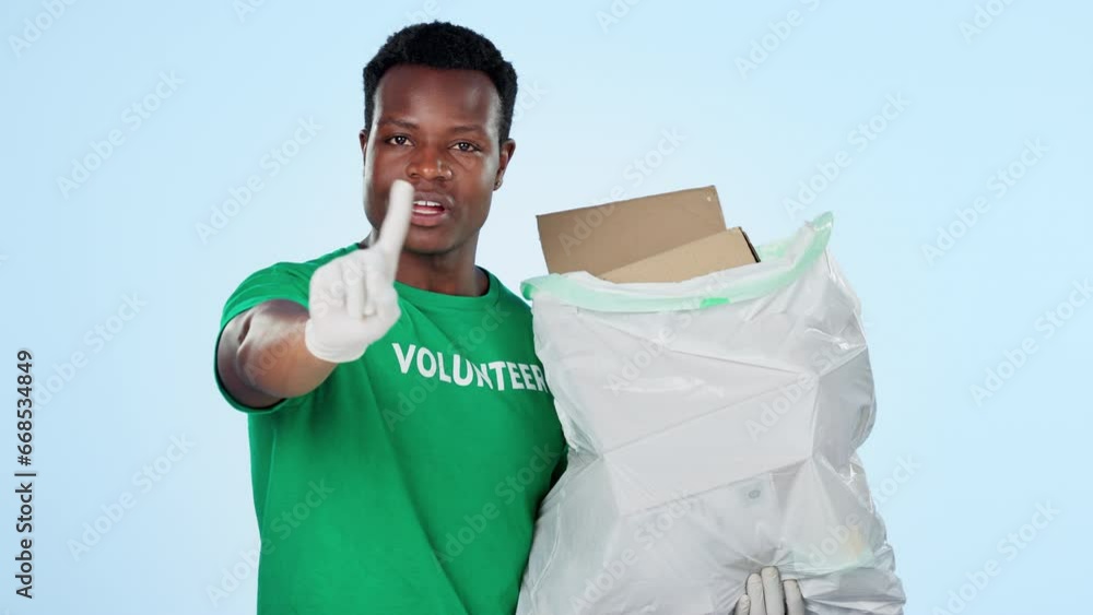 Wall mural Black man, volunteer and garbage for waste, green and activism for littering, sustainability and clean. Climate change, plastic and blue studio background for pollution, recycle and accountability