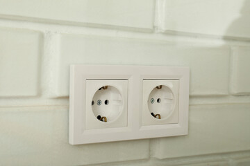 Electric white sockets on a white wall