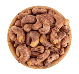 cashew nuts with shell in wooden bowl isolated on white background. Top view. Flat lay