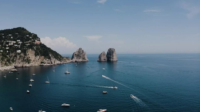 Drone shot of boats cruising through Italy's coastal waters.