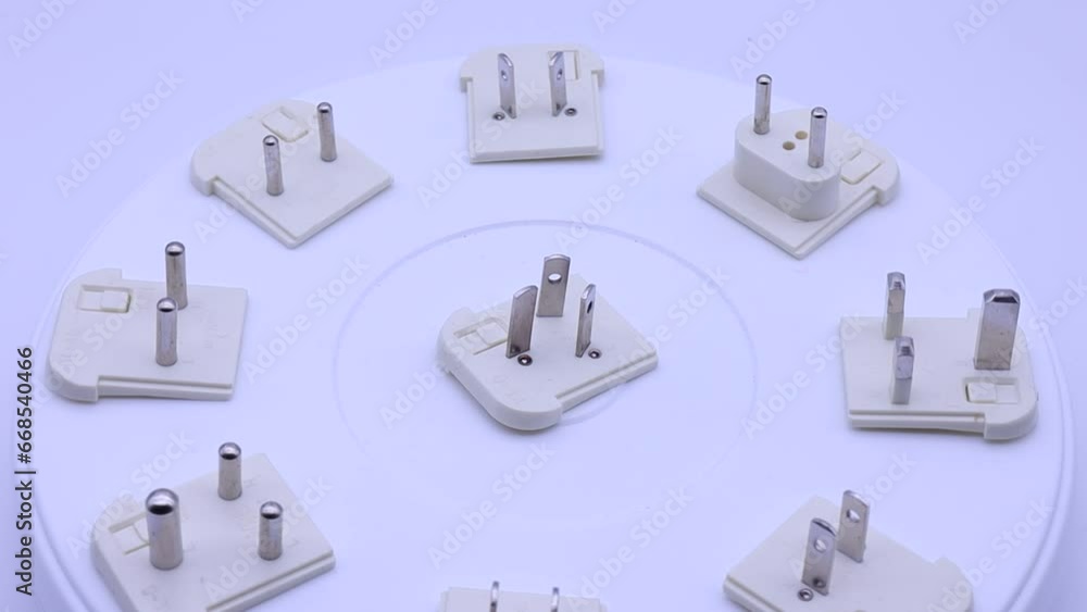 Poster a collection of electrical socket adapters for different countries.