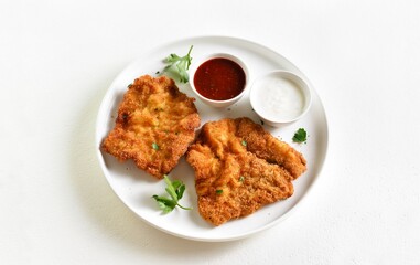 Breaded wiener schnitzel with sauce