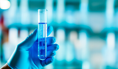 Test tube with blue sample chemicals or liquid in laboratory. Glassware in medical research. Scientific lab for Biotechnology. Shallow field of view with copy space.