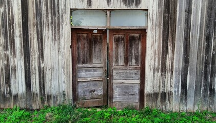 old wooden house front with wooden entrance