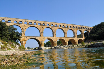 The old Roman Viaduct Pont du Gard in the south of France in the Provence region. Historical monument building.