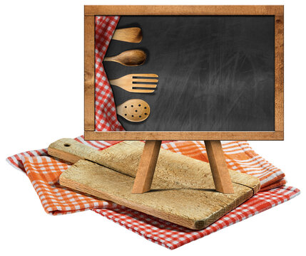 Old wood cutting board and empty blackboard with wooden kitchen utensils and copy space, on checkered tablecloths, red, orange and white. Isolated on white or transparent background, photography. Png.