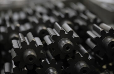 Obraz premium Close-up of metal cogs nested in new modern factories for rapid and transit production of different of details .Automotive manufacturing process concept