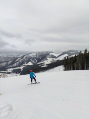 Fototapeta na wymiar snowboarder at ski slope mountains landscape on background