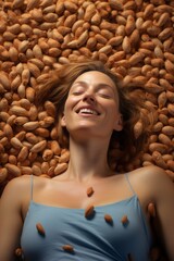 A woman lying in a field of almond. Woman is laughing and surrounded by almond.