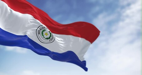 Slow motion loop of Paraguay flag waving against clear sky