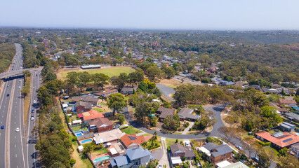 Fototapeta na wymiar Aerial drone view of homes and streets above Bangor in the Sutherland Shire, south Sydney, NSW Australia showing Bangor Bypass in the background 