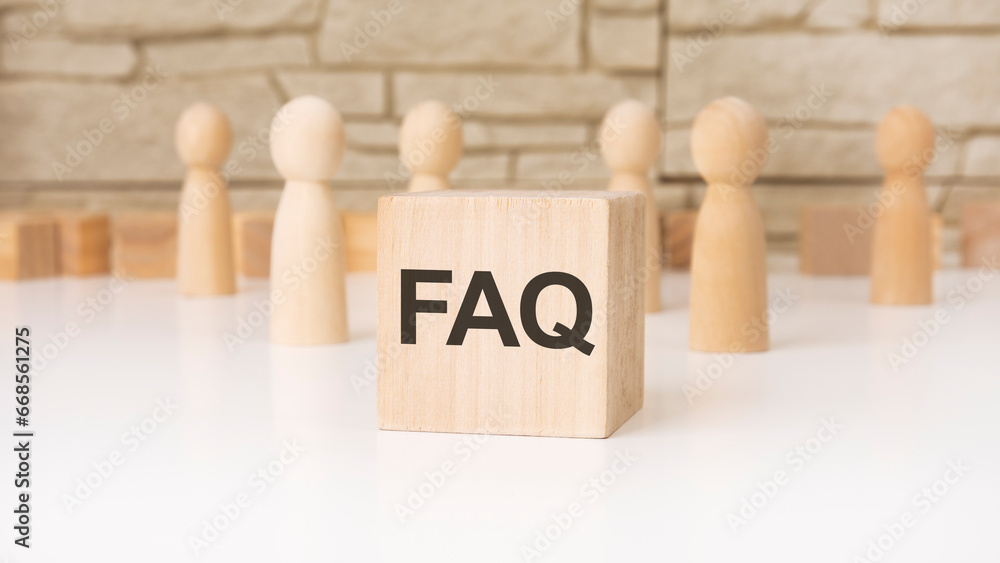 Aufkleber faq - 'frequency asked questions' wooden blocks with letters, help concept, front view on grey backg