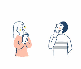 上の方を見ながら喜ぶ若いカップル