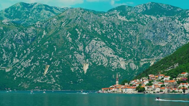 seascape, view from ship to mountains and Perast city, bay of Kotor, Montenegro, bright sunny day, summer travel concept
