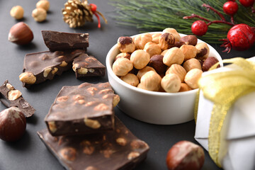 Chocolate with hazelnuts on black christmas table elevated view