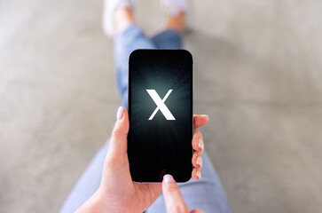 Mobile phone with a letter X on the screen. Custom made font, not a trademark. - 668569409