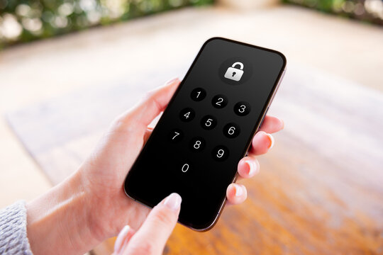 Person entering pin code to unlock the phone's screen