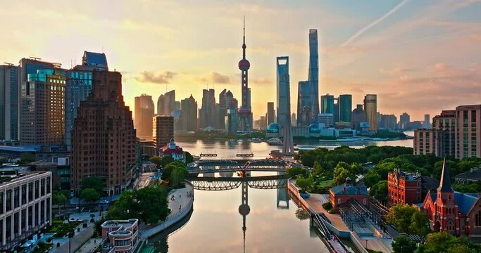 Aerial view of Shanghai city skyline and skyscrapers scenery at sunrise, China. Famous city landmark. Drone ascending to shoot.