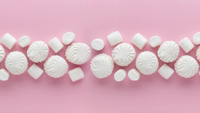 Soft white vanilla zephyr on light pink table. Pastel color. Video with empty space for the text