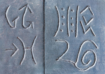 wooden african ancient symbols at a flea market polished with some patina to make it look like an old artifact