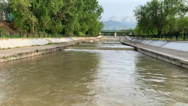 Almaty, KAZAKHSTAN. Water flowing from the top of the Northern Tien-Shan Mountains next to the park of the first president of Kazakhstan. Panoramic view